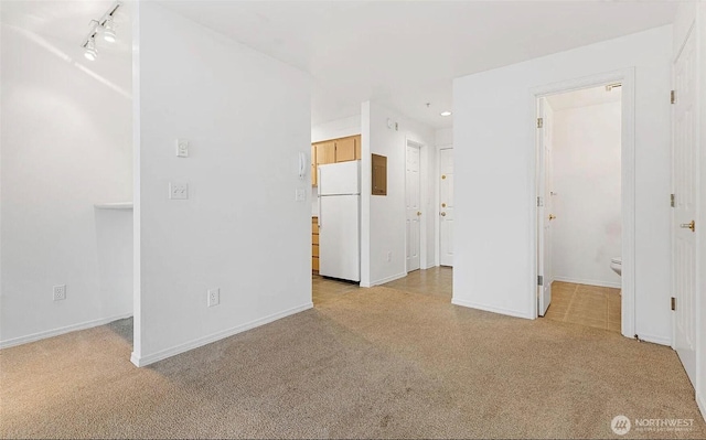 unfurnished living room with light carpet, baseboards, track lighting, and recessed lighting