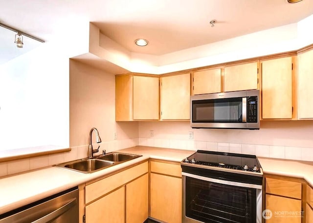 9221 Interlake Ave N Unit 208, Seattle, WA 98103 - kitchen with stainless steel appliances, light countertops, decorative backsplash, light brown cabinets, and recessed lighting