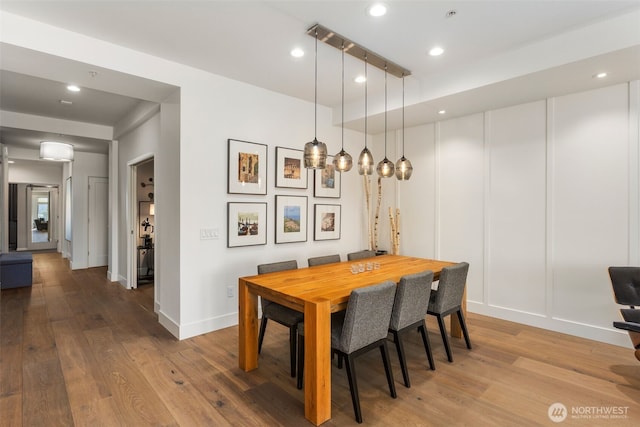 dining room featuring recessed lighting, baseboards, and wood finished floors