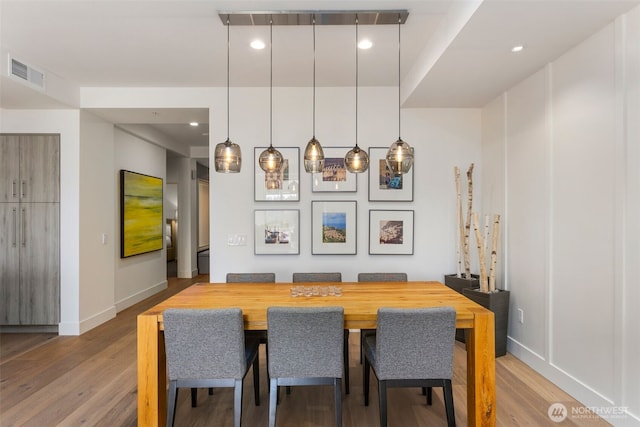 dining room with recessed lighting, wood finished floors, visible vents, and baseboards