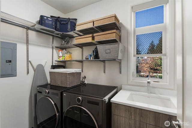 laundry area featuring washer and dryer, laundry area, electric panel, and a sink