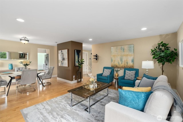 living area with recessed lighting, wood finished floors, and baseboards