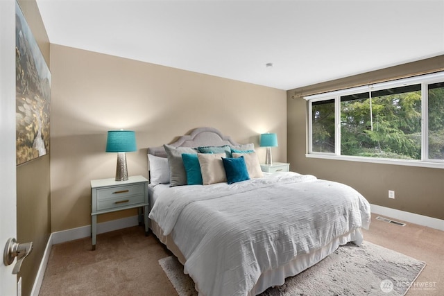 bedroom featuring visible vents, carpet floors, and baseboards