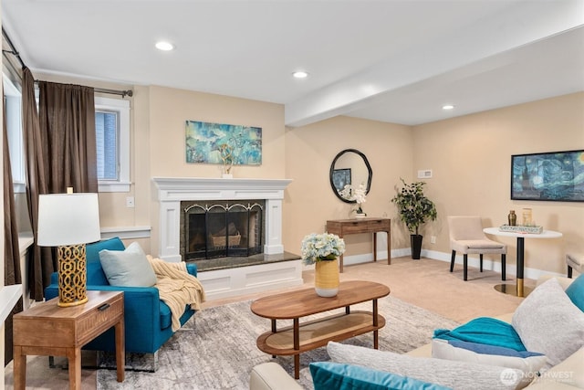 living area featuring recessed lighting, a fireplace with raised hearth, baseboards, and carpet floors