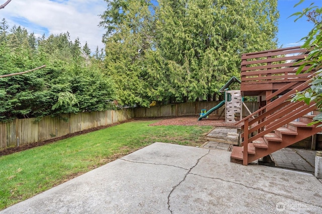 view of yard with a patio area, a playground, and a fenced backyard