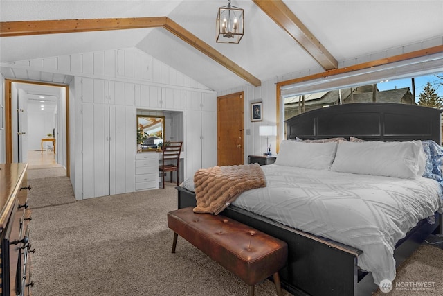 carpeted bedroom featuring lofted ceiling with beams, wooden walls, and a notable chandelier