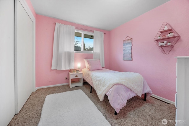 carpeted bedroom featuring baseboards