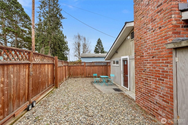 view of yard with a patio area and a fenced backyard