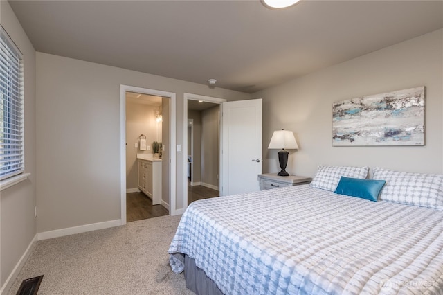 carpeted bedroom with visible vents and baseboards