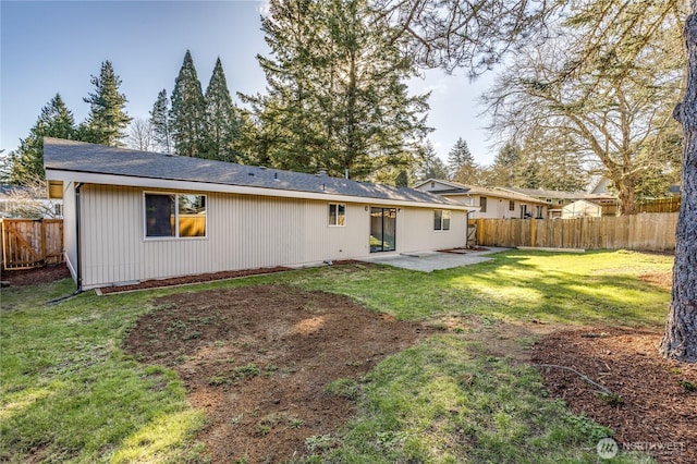 back of house featuring a yard, a fenced backyard, and a patio