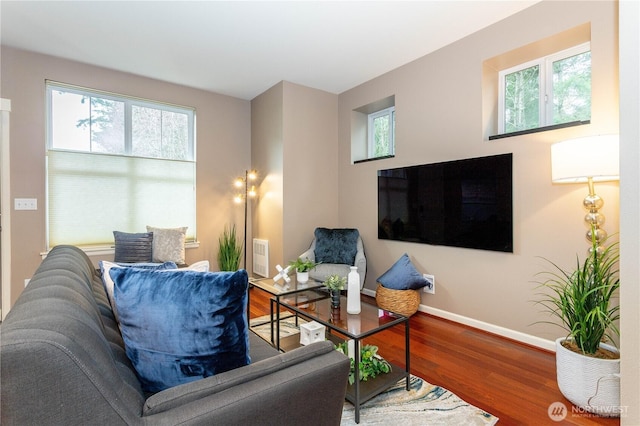 living room featuring baseboards and wood finished floors