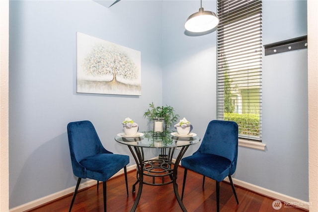 interior space featuring baseboards and wood finished floors