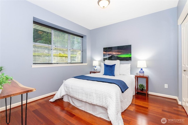 bedroom with baseboards and wood finished floors