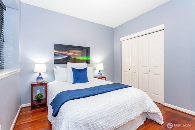 bedroom featuring a closet, wood finished floors, and baseboards