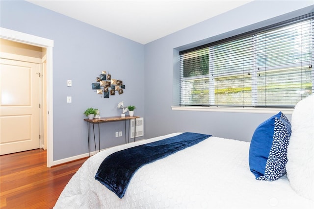 bedroom featuring baseboards and wood finished floors