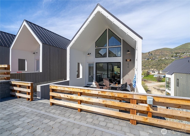 back of house with a mountain view and metal roof