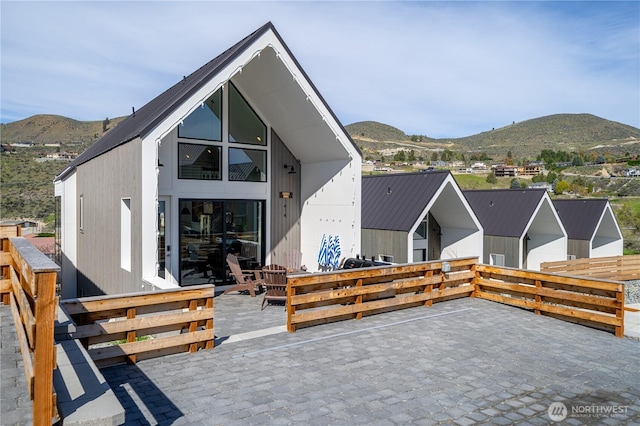 back of house featuring a mountain view and a patio