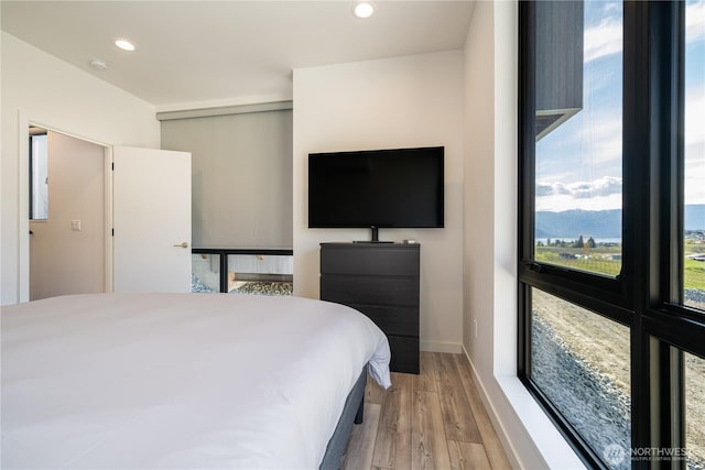 bedroom featuring wood finished floors and recessed lighting