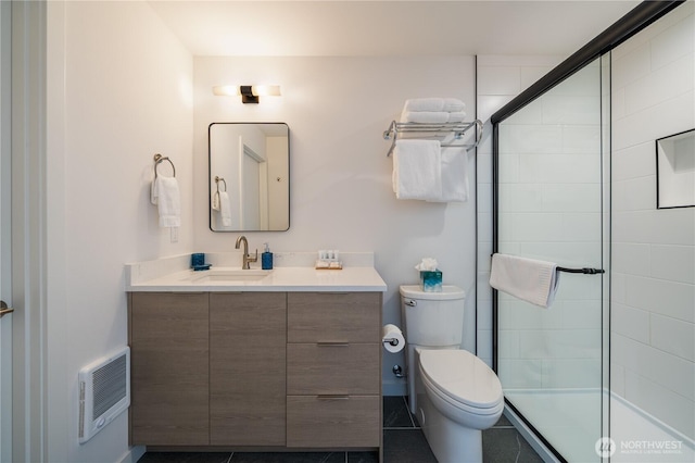 bathroom featuring a stall shower, vanity, toilet, and heating unit