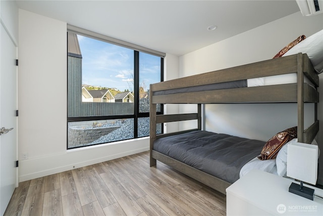 bedroom featuring baseboards and wood finished floors