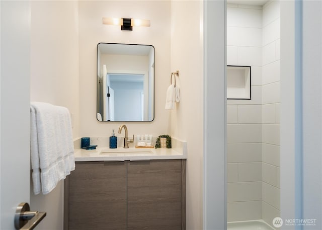 bathroom featuring a shower and vanity