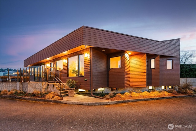 contemporary house featuring fence