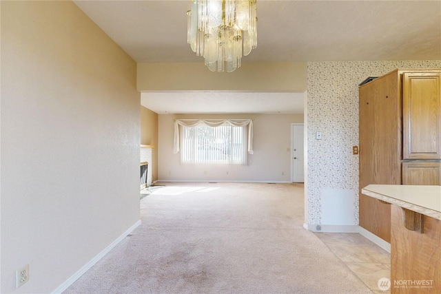 515 SE 5th St, College Place, WA 99324 - unfurnished dining area featuring a chandelier, light colored carpet, a fireplace, baseboards, and wallpapered walls