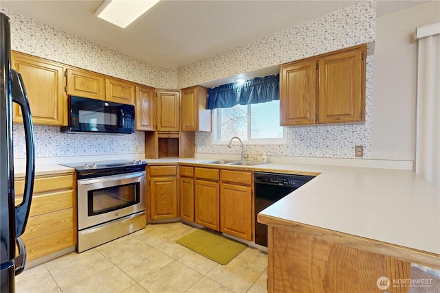 515 SE 5th St, College Place, WA 99324 - kitchen featuring a peninsula, light countertops, black appliances, a sink, and light tile patterned flooring