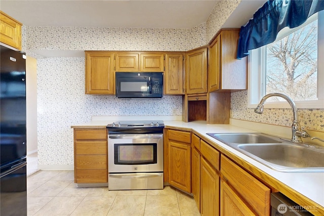515 SE 5th St, College Place, WA 99324 - kitchen featuring a sink, black appliances, wallpapered walls, and light tile patterned flooring