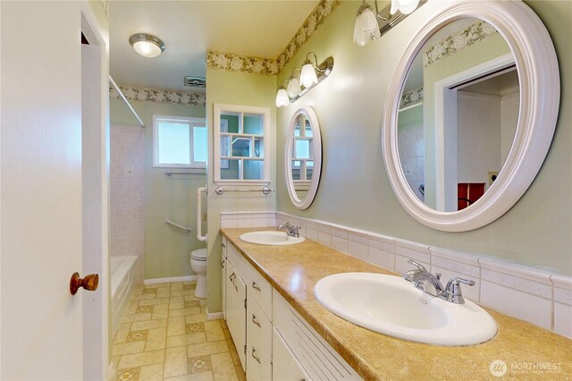 515 SE 5th St, College Place, WA 99324 - full bath with double vanity, a sink, toilet, and baseboards
