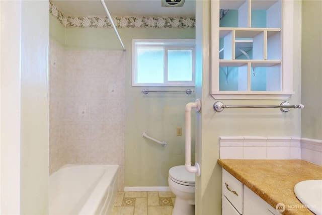 515 SE 5th St, College Place, WA 99324 - full bathroom with toilet, washtub / shower combination, stone finish flooring, vanity, and baseboards