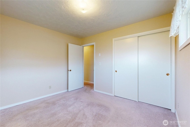 515 SE 5th St, College Place, WA 99324 - unfurnished bedroom with a textured ceiling, carpet floors, a closet, and baseboards