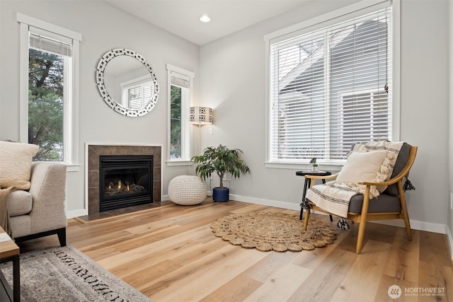 sitting room with a healthy amount of sunlight and wood finished floors