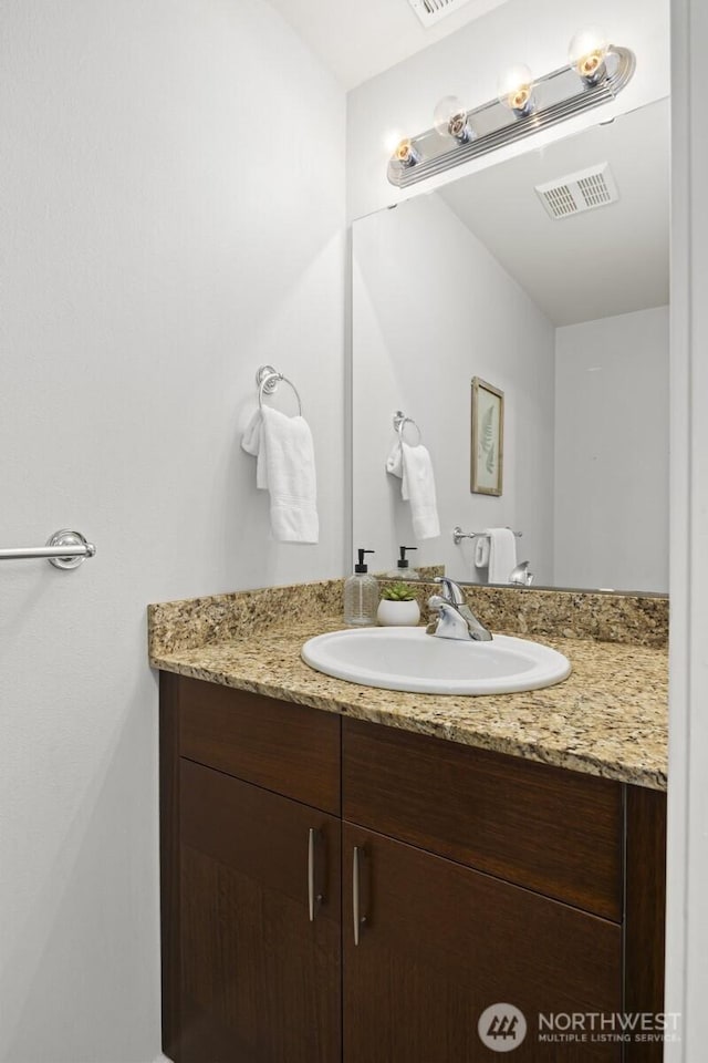 bathroom featuring vanity and visible vents