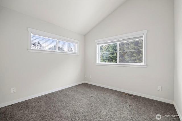 unfurnished room featuring carpet floors, lofted ceiling, visible vents, and baseboards