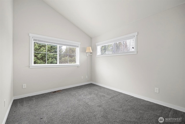 carpeted empty room featuring lofted ceiling, visible vents, and baseboards