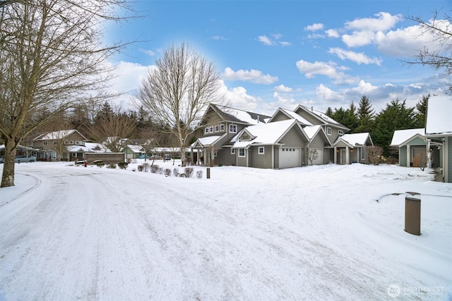 yard covered in snow featuring a residential view and an attached garage