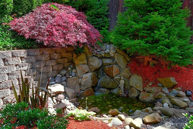 exterior details with a small pond