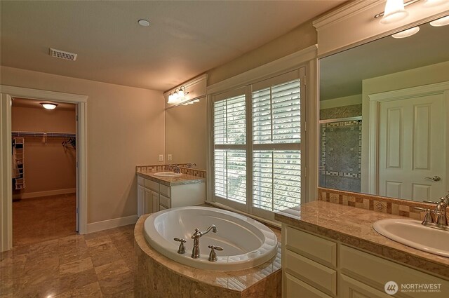 full bathroom with a stall shower, visible vents, a sink, and a bath