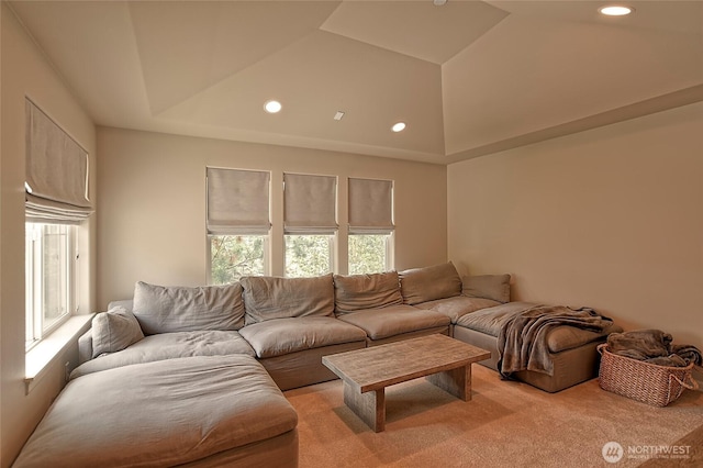 living area featuring recessed lighting, light carpet, and a towering ceiling