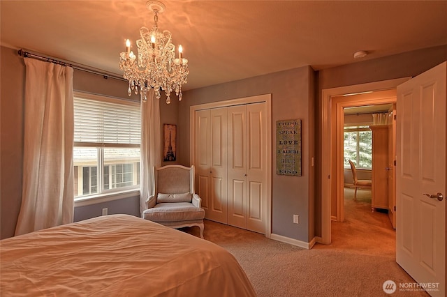 bedroom with a notable chandelier, a closet, carpet flooring, and baseboards