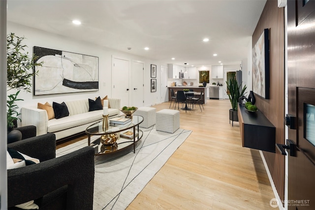 living area with recessed lighting and light wood-style flooring