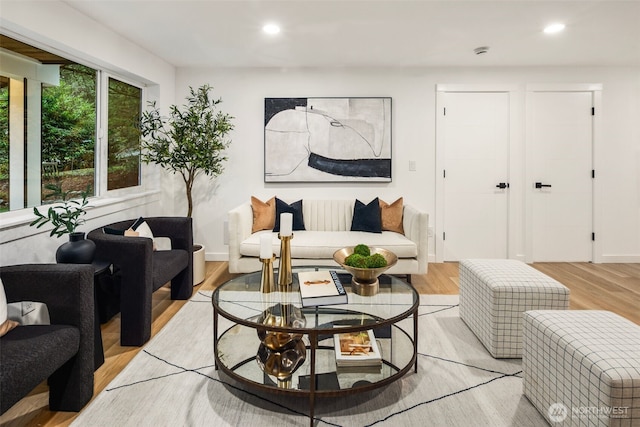 living area featuring recessed lighting, light wood-type flooring, and baseboards