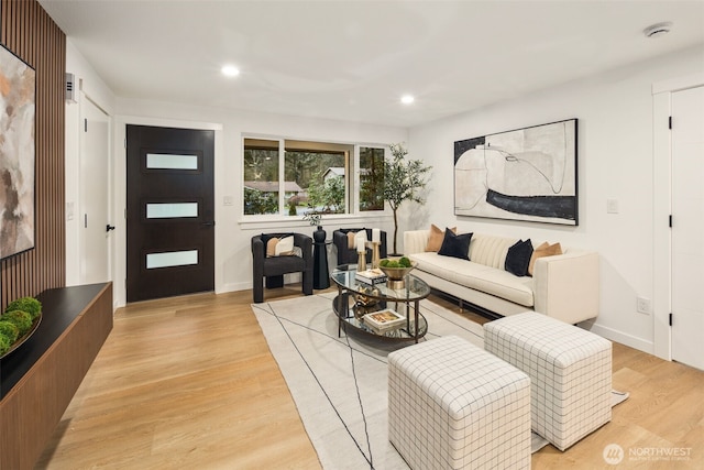 living area with recessed lighting, baseboards, and light wood-style floors