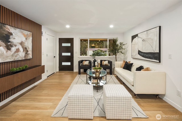 living area with recessed lighting, light wood-style floors, and baseboards