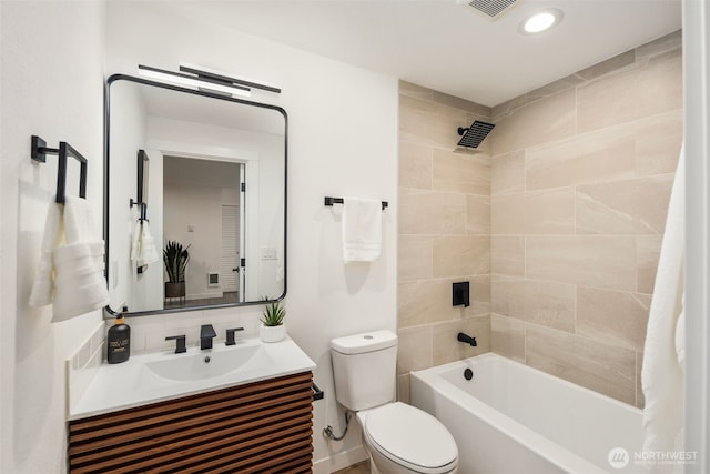 bathroom featuring visible vents, toilet, vanity, and bathtub / shower combination