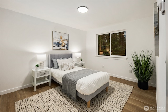 bedroom featuring baseboards and wood finished floors