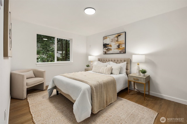 bedroom featuring wood finished floors and baseboards