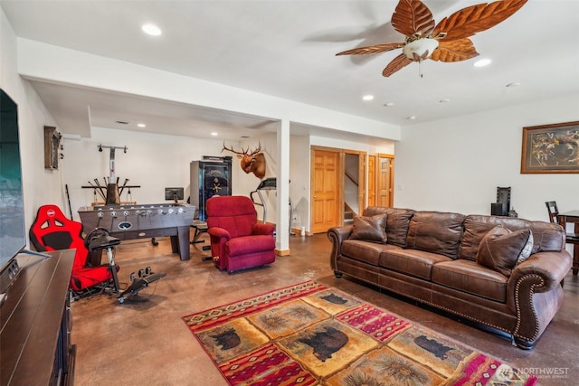 living room featuring finished concrete flooring, stairway, a ceiling fan, and recessed lighting