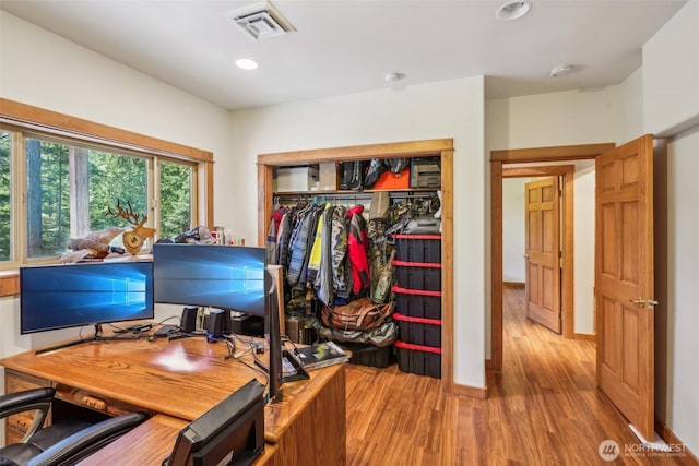 office featuring recessed lighting, visible vents, baseboards, and wood finished floors